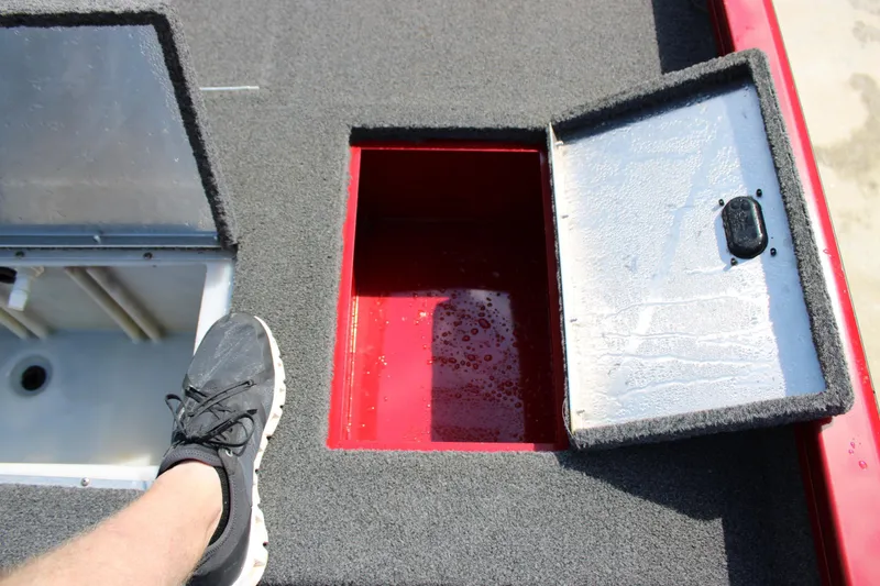 Slide: The Image of Open storage compartments on a 2018 Lowe Stinger 175C boat deck. - 11