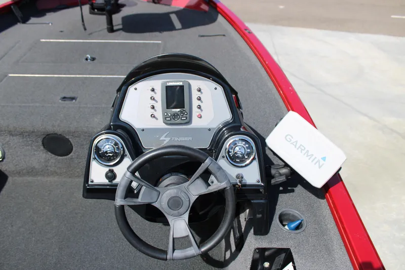 Slide: The Image of 2018 Lowe Stinger 175C boat dashboard with steering wheel, Lowrance display, and Garmin device. - 12