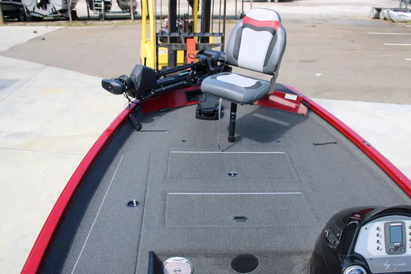 Slide: The Image of 2018 Lowe Stinger 175C fishing boat with gray seating and red trim, docked outdoors. - 4