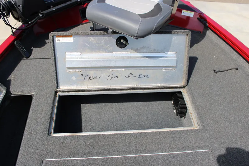 Slide: The Image of 2018 Lowe Stinger 175C boat storage compartment with motivational quote "Never give up" by Ike. - 7