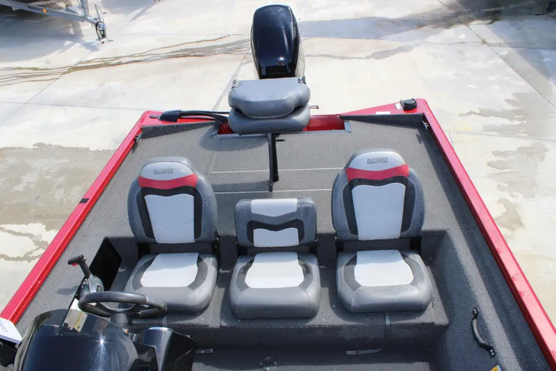 Slide: The Image of 2018 Lowe Stinger 175C boat interior with three gray and red seats, steering wheel visible. - 9