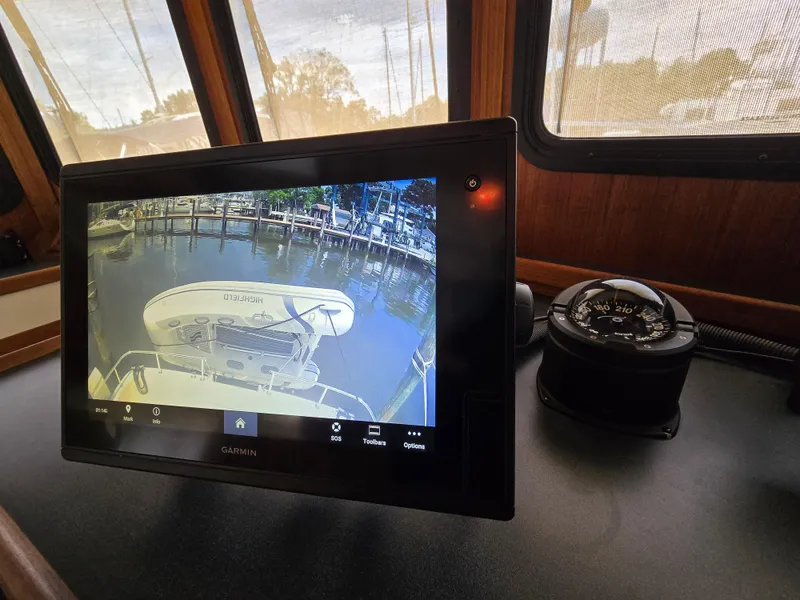 Slide: The Image of Pilothouse of a 2001 Nordic Tug 32 with navigation equipment and wooden steering wheel. - 10