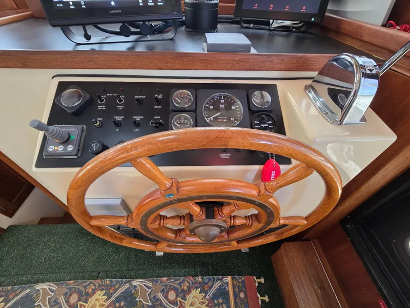 Slide: The Image of Raymarine navigation display on 2001 Nordic Tug 32 boat, showing charts and radar options. - 11