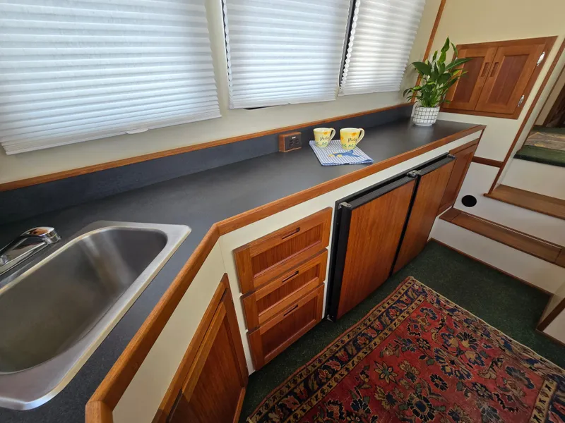 Slide: The Image of Interior of a 2001 Nordic Tug 32 showing open fridge with beverages. - 18