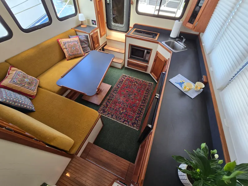 Slide: The Image of 2001 Nordic Tug 32 boat docked in a marina, featuring classic design and green accents. - 4