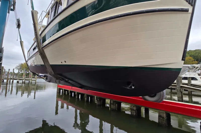 Slide: The Image of 2001 Nordic Tug 32 with Seakeeper being lifted from water at a marina. - 51