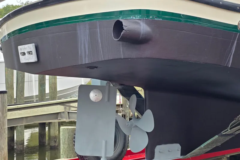 Slide: The Image of 2001 Nordic Tug 32 with Seakeeper, showcasing hull and propeller details at dock. - 53