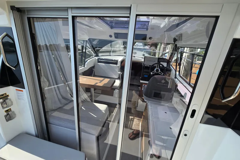 Slide: The Image of Interior view of 2023 Jeanneau NC Sport 795 Series 2 boat, featuring helm and seating area. - 23