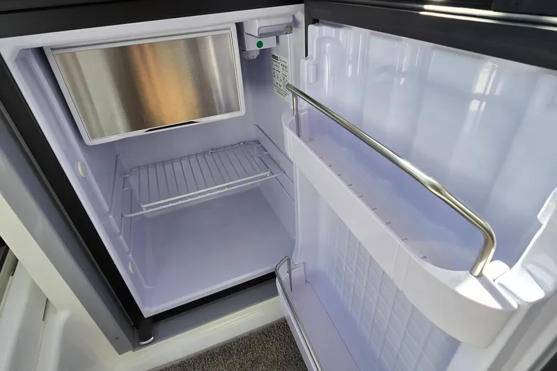 Slide: The Image of Open fridge inside 2023 Jeanneau NC Sport 795 Series 2 boat. - 26