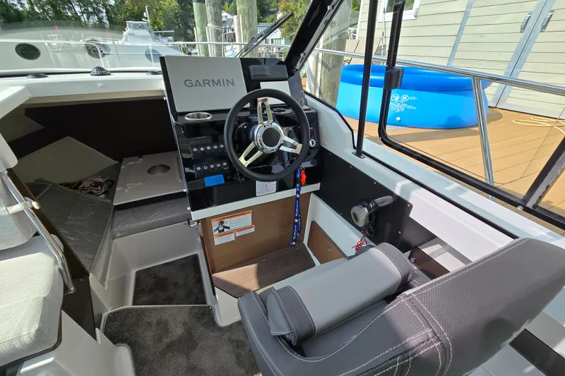 Slide: The Image of 2023 Jeanneau NC Sport 795 Series 2 cockpit with Garmin navigation system and modern steering wheel. - 28