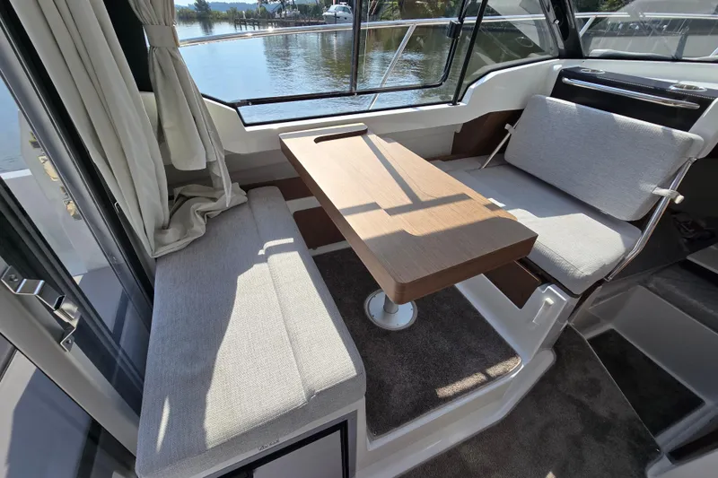 Slide: The Image of Interior of 2023 Jeanneau NC Sport 795 Series 2 boat with seating and table. - 29