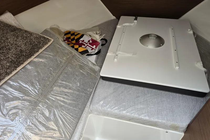 Slide: The Image of 2023 Jeanneau NC Sport 795 Series 2 interior with cushions and storage area. - 33