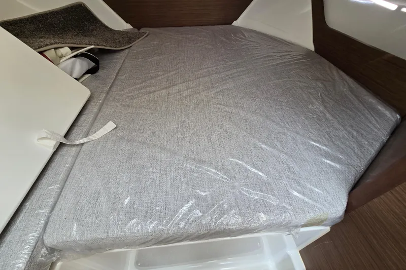Slide: The Image of Interior cabin of 2023 Jeanneau NC Sport 795 Series 2 with cushioned bedding. - 35