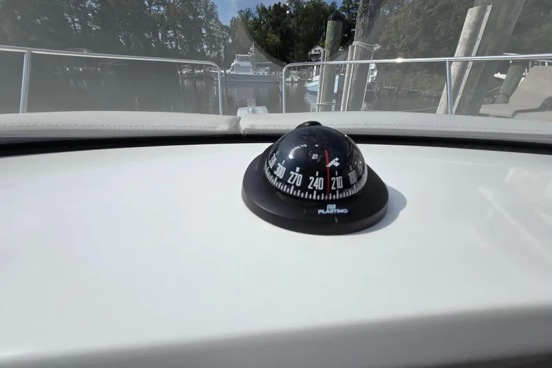 Slide: The Image of Compass on 2023 Jeanneau NC Sport 795 Series 2 boat dashboard, docked in marina. - 40