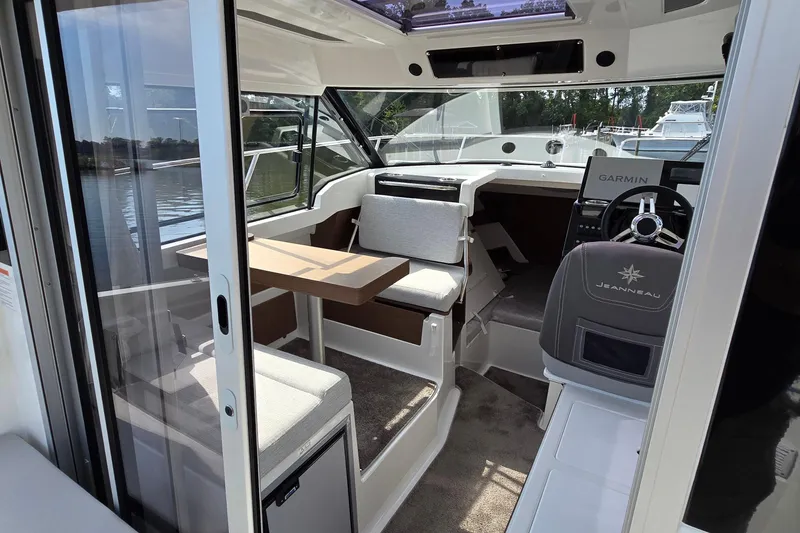 Slide: The Image of 2023 Jeanneau NC Sport 795 Series 2 interior with helm, seating, and table. - 51