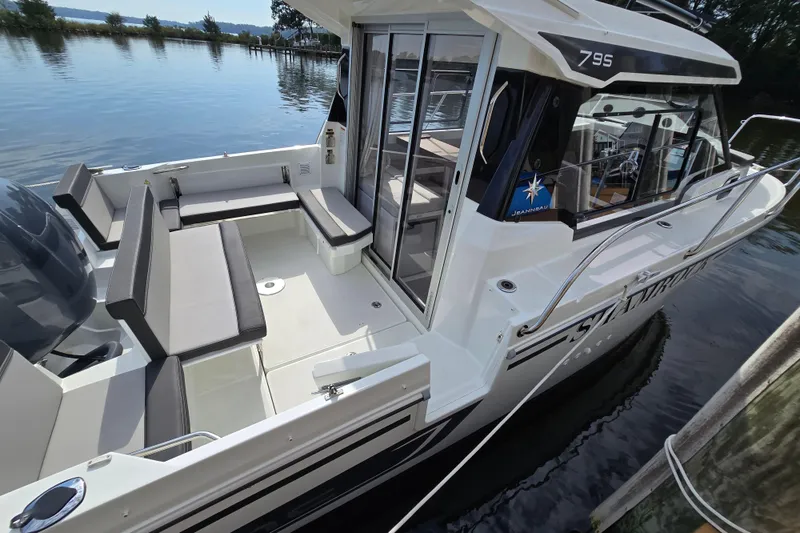 Slide: The Image of 2023 Jeanneau NC Sport 795 Series 2 boat, featuring spacious seating and sleek design on calm water. - 53