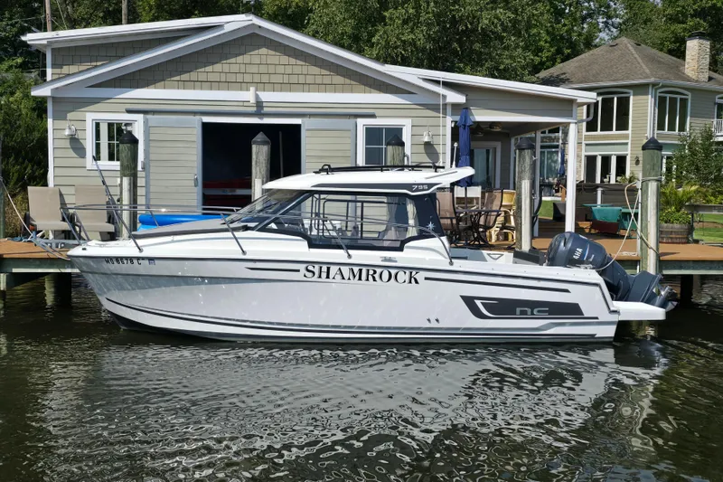 Slide: The Image of 2023 Jeanneau NC 795 Series 2 boat docked by a waterfront house. - 56