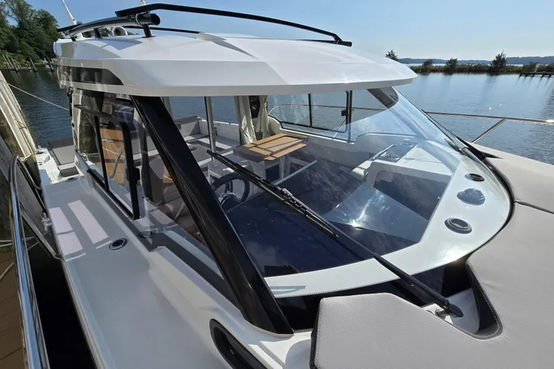 Slide: The Image of 2023 Jeanneau NC Sport 795 Series 2 boat docked by a serene lake. - 7