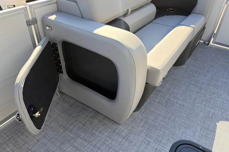 Slide: The Image of Sun Tracker Party Barge 22 RF XP3, 2026 model, featuring open storage compartment and seating. - 16