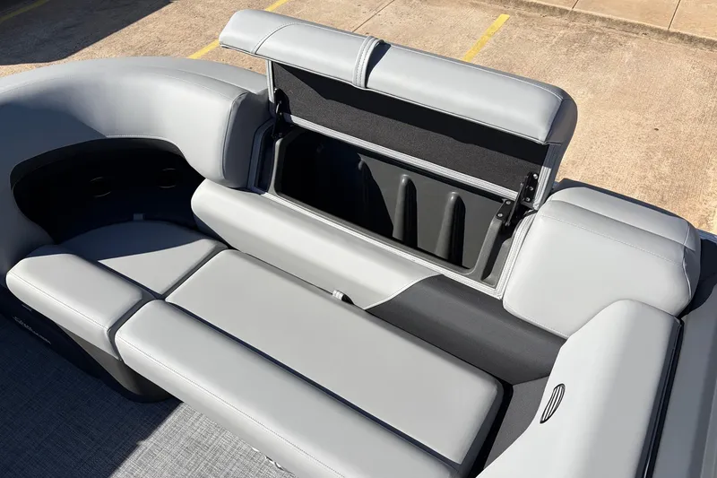 Slide: The Image of 2026 Sun Tracker Party Barge 22 RF XP3 with open storage compartment and gray seating. - 25