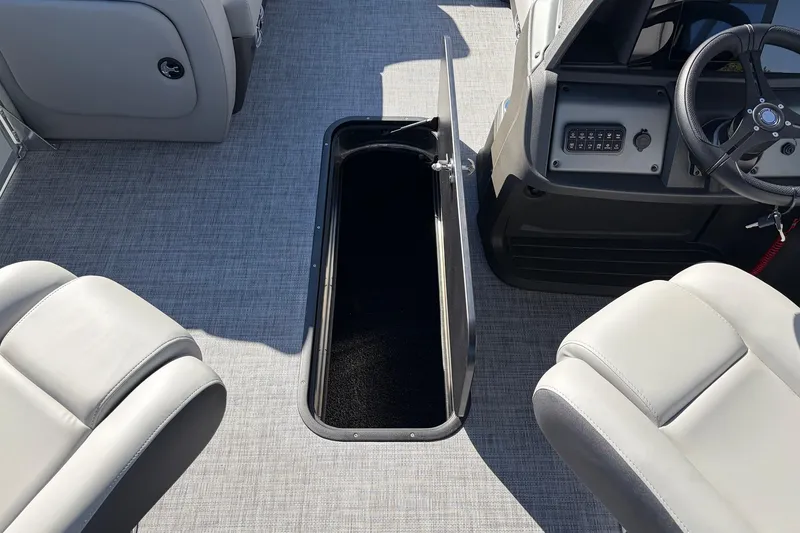 Slide: The Image of 2026 Sun Tracker Party Barge 22 RF XP3 interior with open storage compartment and seating. - 29