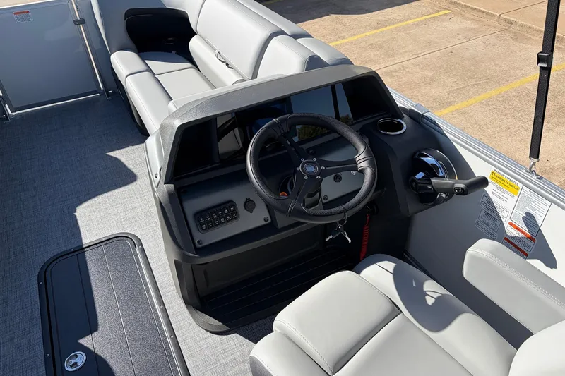 Slide: The Image of 2026 Sun Tracker Party Barge 22 RF XP3 boat interior with steering wheel and seating. - 33