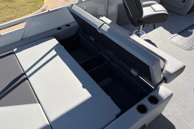 Slide: The Image of 2026 Sun Tracker Party Barge 22 RF XP3 interior with open storage compartment and seating. - 51