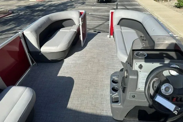Slide: The Image of 2026 Sun Tracker Party Barge 16 DLX interior with spacious seating and modern helm. - 13