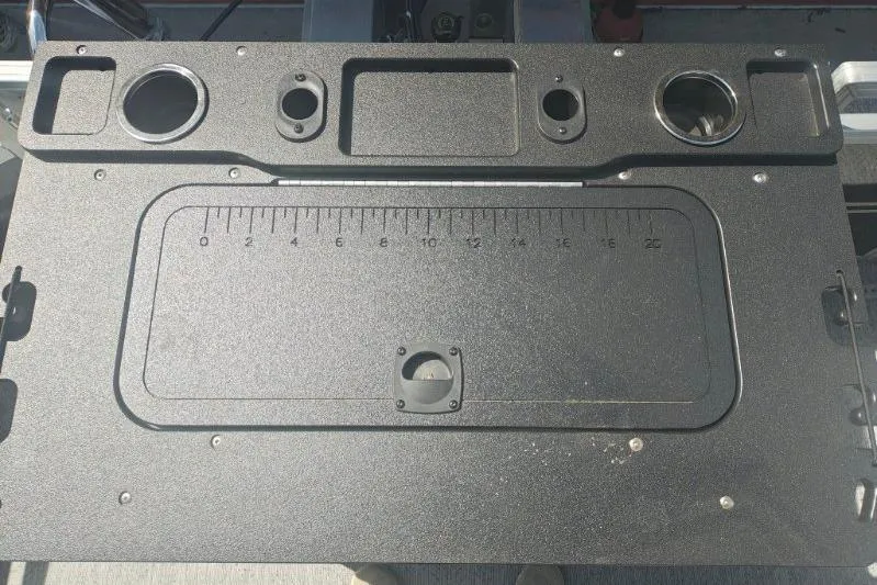 Slide: The Image of 2026 Sun Tracker Fishin' Barge 20 DLX fishing station with integrated ruler and cup holders. - 11