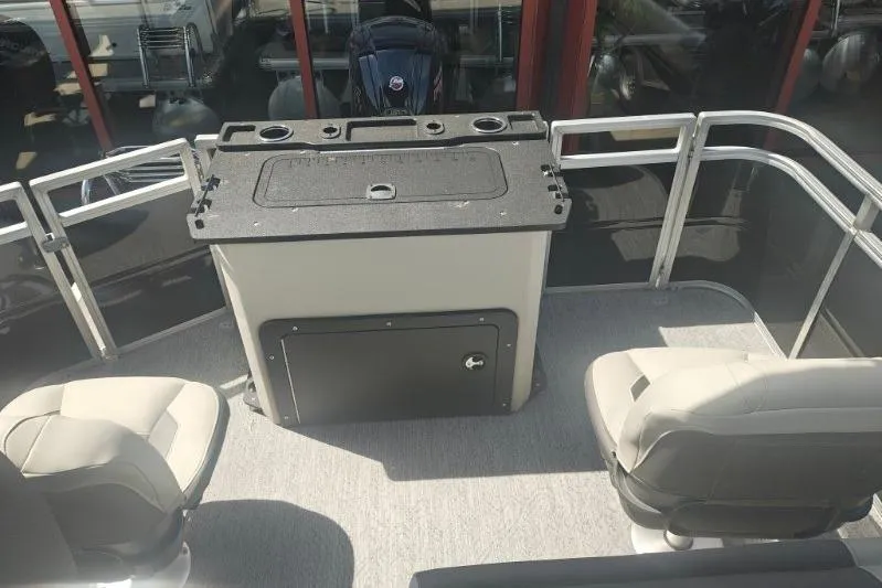 Slide: The Image of 2026 Sun Tracker Fishin' Barge 20 DLX interior with seating and storage. - 12