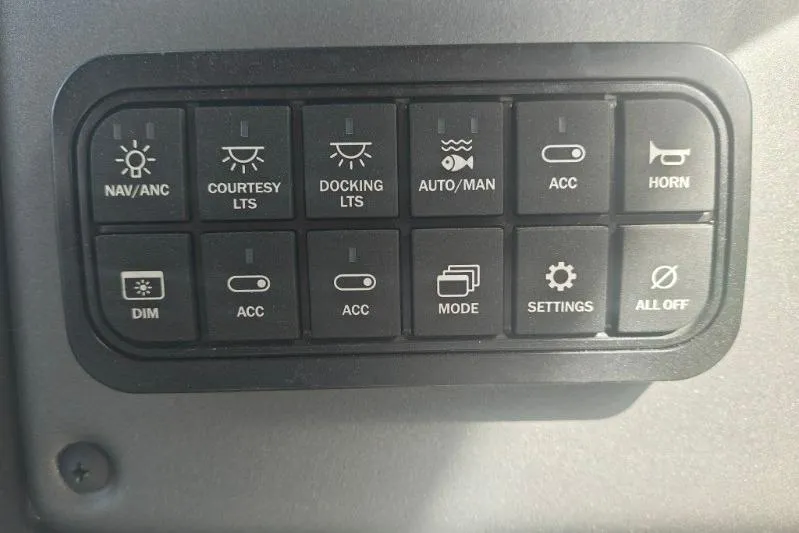 Slide: The Image of Control panel of 2026 Sun Tracker Fishin' Barge 20 DLX with various function buttons. - 13