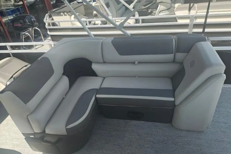 Slide: The Image of 2026 Sun Tracker Fishin' Barge 20 DLX pontoon boat seating area, featuring gray upholstery. - 16