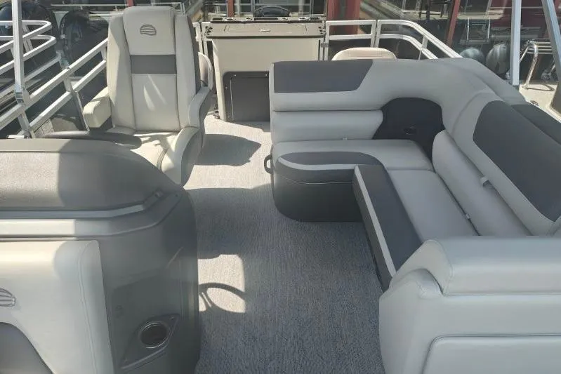 Slide: The Image of 2026 Sun Tracker Fishin' Barge 20 DLX interior with plush seating and modern design. - 17
