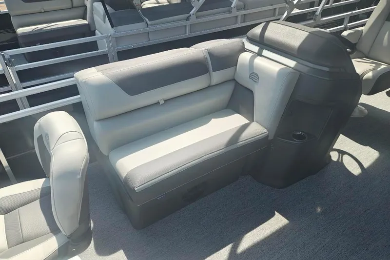 Slide: The Image of 2026 Sun Tracker Fishin' Barge 20 DLX interior with gray seating and console. - 20