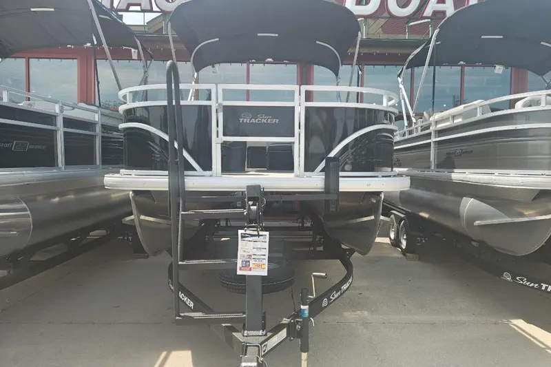 Slide: The Image of 2026 Sun Tracker Fishin' Barge 20 DLX pontoon boat displayed at dealership. - 24