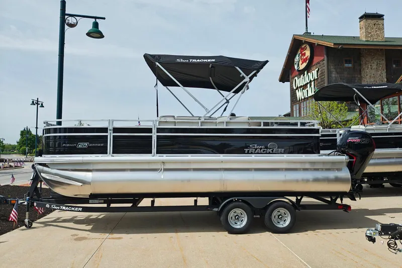 Slide: The Image of 2026 Sun Tracker Fishin' Barge 20 DLX pontoon boat displayed outdoors. - 25