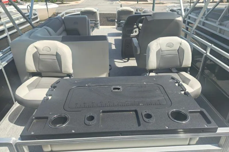 Slide: The Image of 2026 Sun Tracker Fishin' Barge 20 DLX interior with seating and fishing station. - 9