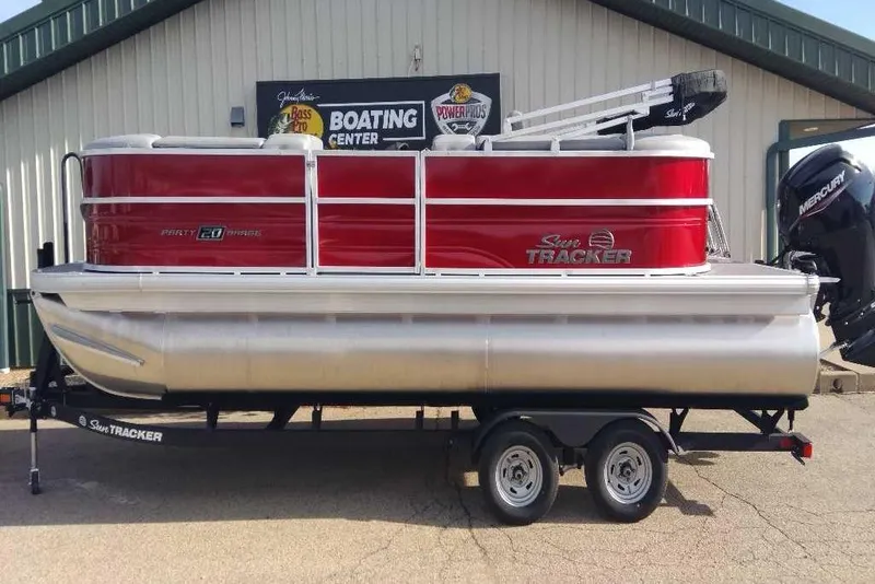 Slide: The Image of 2026 Sun Tracker Party Barge 20 DLX pontoon boat on trailer, red and silver design. - 73
