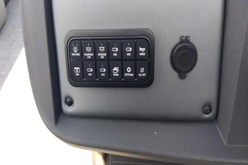 Slide: The Image of Control panel of 2026 Sun Tracker Party Barge 20 DLX with various function buttons. - 76