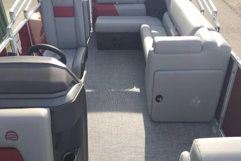 Slide: The Image of 2026 Sun Tracker Party Barge 20 DLX interior with gray seating and steering console. - 77