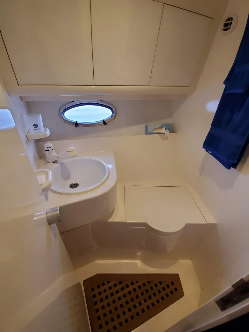 Slide: The Image of Compact bathroom in a 1993 Giorgi 46 boat with sink, toilet, and porthole. - 21