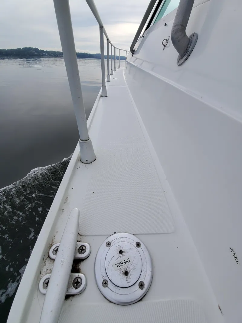 Slide: The Image of Side view of 1993 Giorgi 46 boat on calm water. - 48