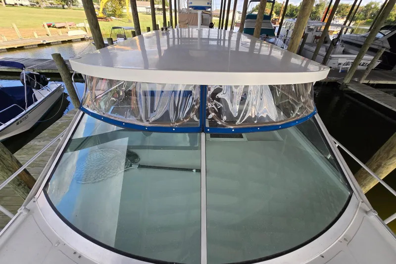 Slide: The Image of Giorgi 46 boat from 1993 docked, featuring a clear windshield and covered top. - 95