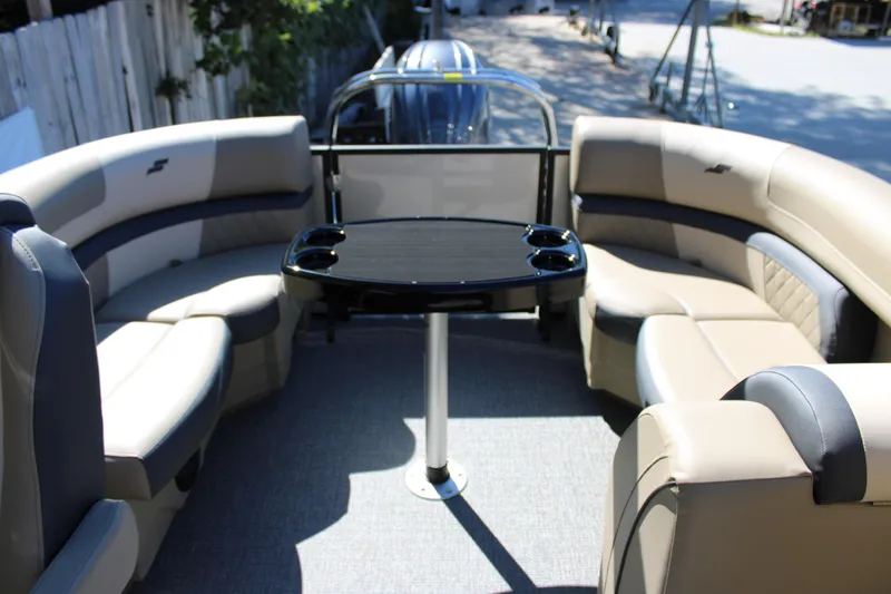Slide: The Image of 2026 Starcraft EXS 1 boat interior with beige seating and central table. - 11