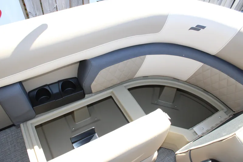 Slide: The Image of 2026 Starcraft EXS 1 boat interior with storage compartment and cup holders. - 12