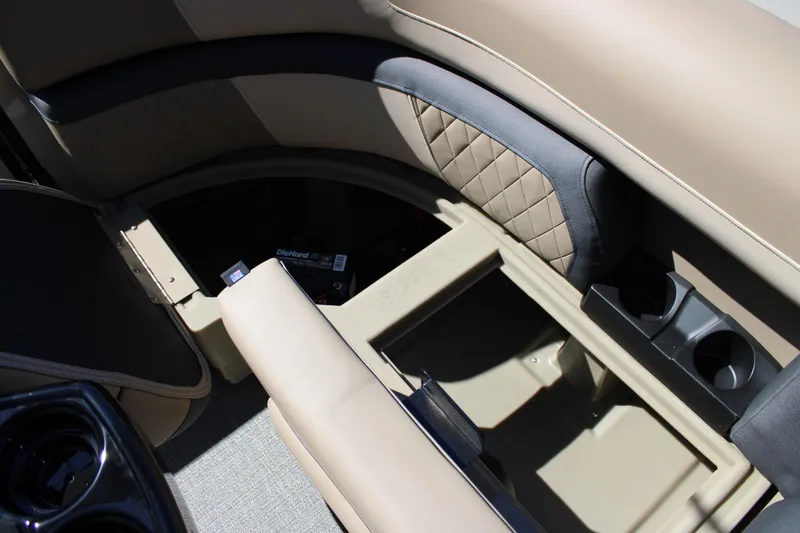 Slide: The Image of Interior storage and seating of 2026 Starcraft EXS 1 boat with cup holders. - 13