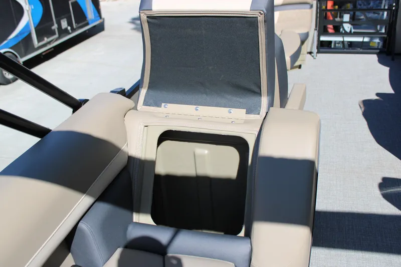 Slide: The Image of 2026 Starcraft EXS 1 boat seat storage compartment, open and empty, with beige and gray upholstery. - 14