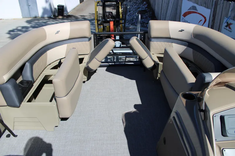 Slide: The Image of 2026 Starcraft EXS 1 boat interior with beige seating and storage compartments. - 18