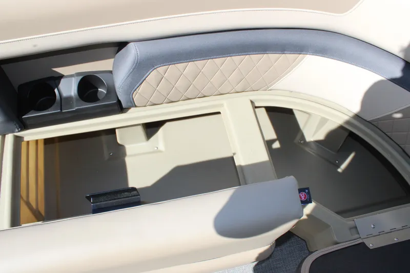 Slide: The Image of 2026 Starcraft EXS 1 boat interior storage compartment with cup holders and quilted upholstery. - 20