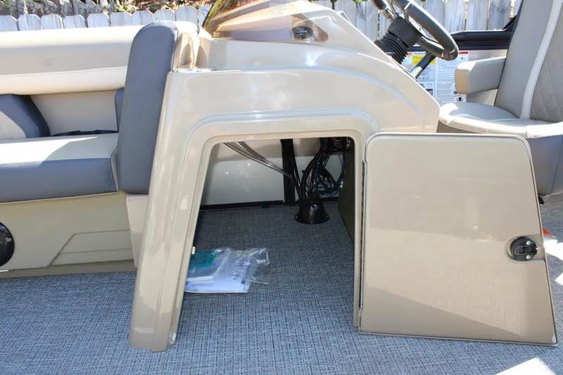 Slide: The Image of Open storage compartment in 2026 Starcraft EXS 1 boat, showcasing interior wiring and seating. - 21